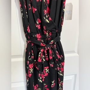 Has never been worn. New with tags!! V-neck jumpsuit. Size M (8-10). Pockets.